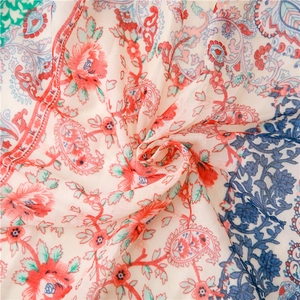 Close-up of paisley floral pattern on soft cotton linen scarf with colorful tassels
