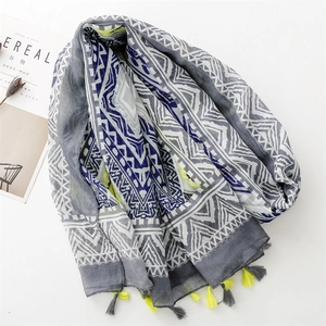 Bohemian geometric pattern scarf with neon yellow tassels on a white background