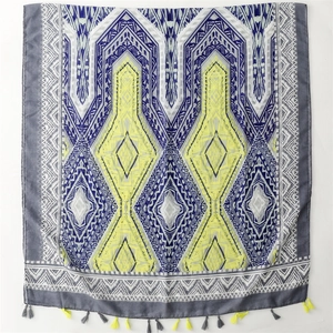 Bohemian geometric scarf with neon yellow and navy patterns and tassel fringe details