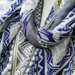 Close-up of geometric pattern on soft bohemian scarf with blue and grey triangle prints