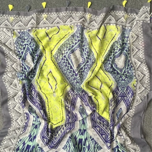 Close-up of Bohemian scarf featuring geometric diamond prints and colorful fringe details
