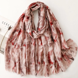 Linen feel scarf with gold foil gradient print and abstract marble pattern on white surface