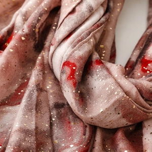 Detail of linen-feel scarf featuring marble print and gold foil stamping texture
