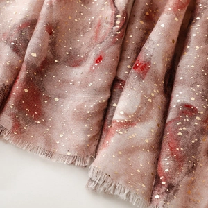 Detail of pink cotton-linen scarf with gold foil dots and gradient ink wash pattern