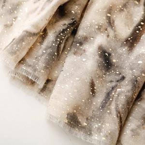 Close-up of linen-feel scarf with gold foil accents and gradient artistic ink texture