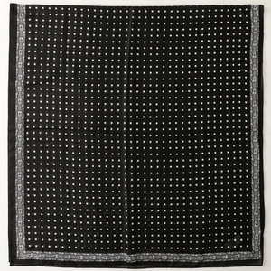 Classic black and white polka dot scarf with paisley border flat lay view