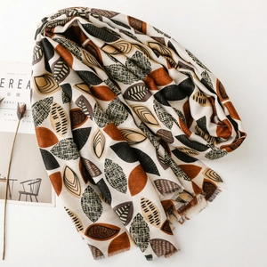 Chic cotton linen feel scarf with leaf print and fringed edges for autumn/winter