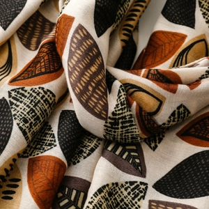 Detailed macro view of woven plant leaf pattern on soft cotton-linen feel scarf