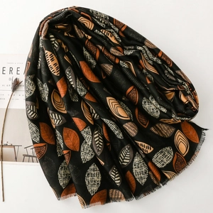 Close-up of soft leaf pattern scarf with fringe edges and natural cotton-linen texture
