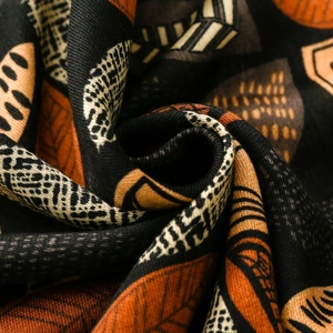 Macro shot of cotton linen scarf with ethnic leaf patterns and twill texture detail
