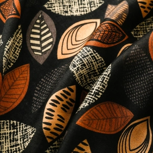 Close-up of cotton linen scarf showing detailed leaf pattern texture and frayed edges