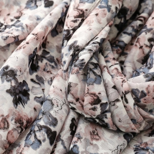 Close-up of semi-transparent floral scarf with breathable linen-feel weave texture
