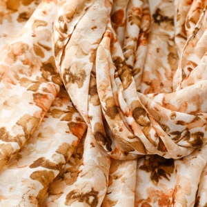 Close-up of cotton-linen feel scarf with vintage floral patterns and soft texture