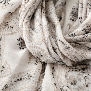 Macro detail of paisley pattern cotton linen scarf with soft fabric texture and elegant folds