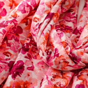 Close-up of soft pink floral cotton linen scarf with watercolor flower patterns