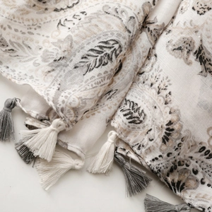 Close-up of vintage paisley pattern on cotton-linen shawl with tassel fringe edges