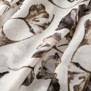 Macro detail of breathable textile fabric featuring vintage autumn leaf print patterns