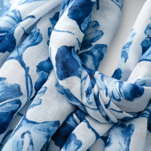 Close-up of blue floral print on lightweight scarf with soft translucent texture