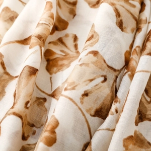Macro detail of scarf fabric showing soft texture and brown ginkgo leaf print