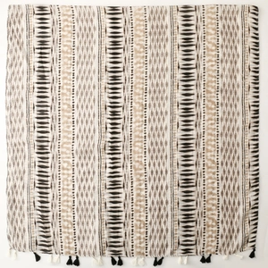 Detail of geometric pattern and fringe tassels on a cotton linen scarf with ethnic style