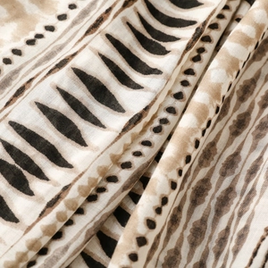 Detail of soft linen-touch fabric with ethnic geometric prints and textured weave