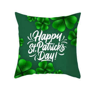 Close-up of Happy St. Patrick's Day lettering on green shamrock pattern pillow cover
