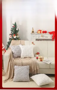 Detail of Christmas plush pillows with embroidered tree textures on a cozy sofa