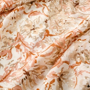 Détail macro du foulard en coton et lin avec imprimé floral et points dorés scintillants