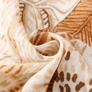 Detail of tropical palm leaf print on soft, breathable fabric with woven texture
