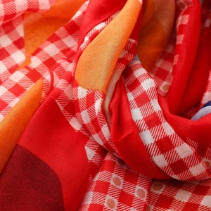 Detail shot of red and white plaid bali yarn scarf with textured geometric patterns