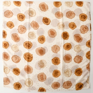 Détail d'une écharpe légère avec des points aquarelle et des finitions dorées