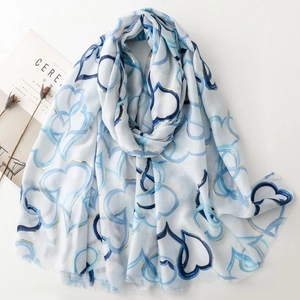 Linen feel scarf with gold heart prints and blue patterns with soft frayed edges