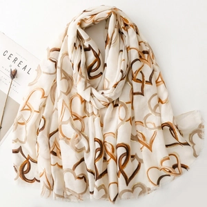 Beige cotton linen scarf with gold foil heart pattern and frayed edges for women