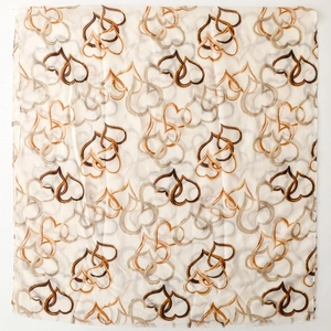 Close-up of interweaving heart patterns on breathable cream cotton-linen feel scarf