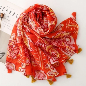 Ethnic bohemian orange floral scarf with colorful tassels for sun protection travel wear