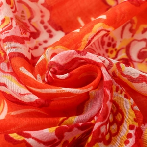 Detail of bohemian orange floral fabric showing soft texture and ethnic print patterns