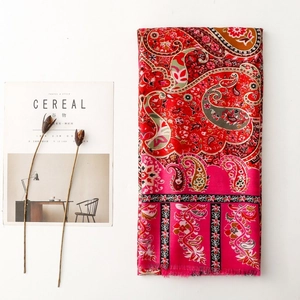 Detail of vintage paisley floral scarf with tassels and vivid ethnic botanical prints
