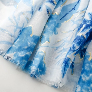 Detail of cotton linen feel scarf with blue watercolor leaves and gold foil printing