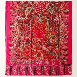 Detail view of ethnic paisley pattern scarf with gold foil printing and fringe edges