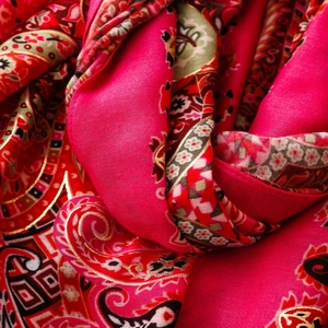 Detail of fuchsia Paisley silk scarf with luxury gold foil prints and intricate patterns