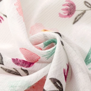 Detail of soft white cotton linen scarf with silver silk threads and pink floral print