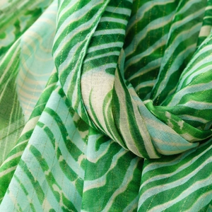 Macro detail of tropical striped fabric with shimmering gold metallic thread weave