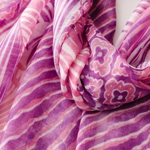 Close-up of tropical purple scarf with gold metallic thread and intricate floral texture