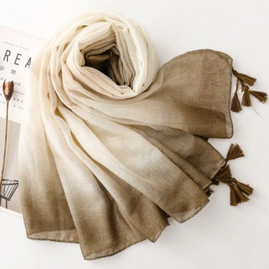 Detail of gradient cotton linen scarf with silver silk threads and stylish fringe edges