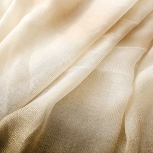 Detailed macro view of ivory linen-feel scarf fabric with fine gold Lurex stripes
