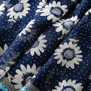 Close-up of bohemian navy scarf with white sunflowers, polka dots and plaid edge