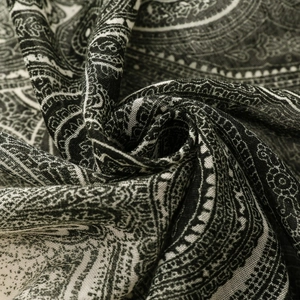 Macro shot of black and white paisley fabric showing detailed weave texture and softness