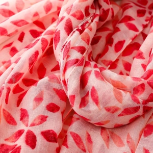 Macro shot of breathable red leaf print scarf showing delicate fabric texture and weave