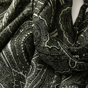 Close-up of black and white paisley print scarf with fine woven texture and soft drape