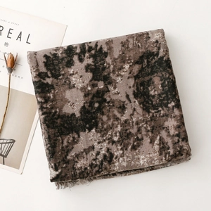 Macro shot of ethnic style scarf with marble texture and delicate fringe details